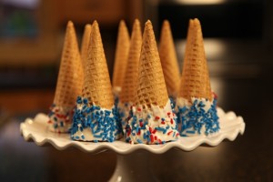 Serve the Sprinkled Sugar Cones on a cake stand